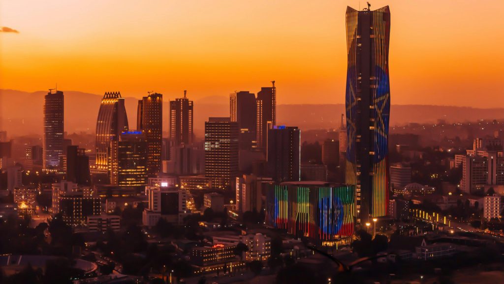 Stunning view of Addis Ababa's skyline against a vibrant sunset backdrop.