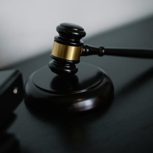 Close-up of a wooden gavel on a desk, symbolizing justice and legal authority.